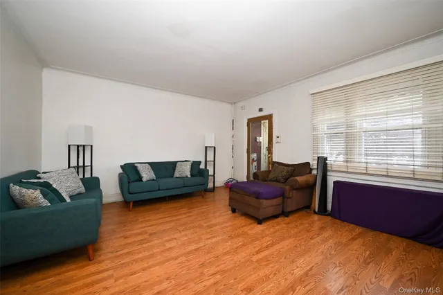 a bedroom with furniture and a wooden floor