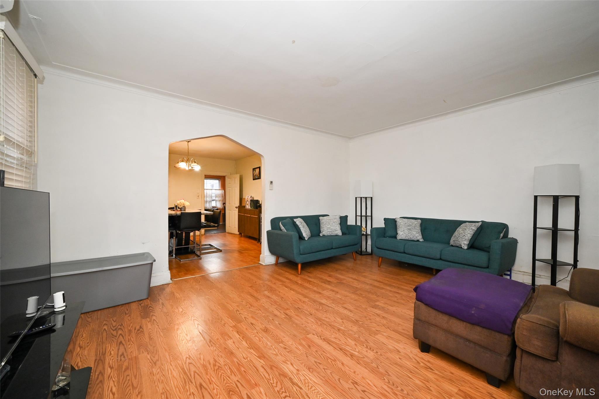 134-21 229th Street Queens, NY 11413 - Photo 5 of 25 a bedroom with furniture and a wooden floor