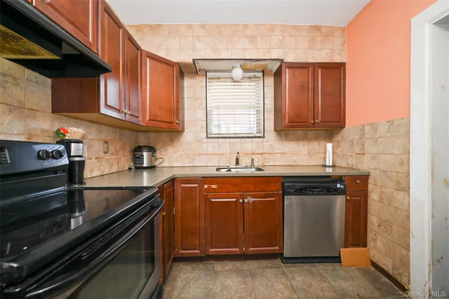 a kitchen with a sink a refrigerator and a stove