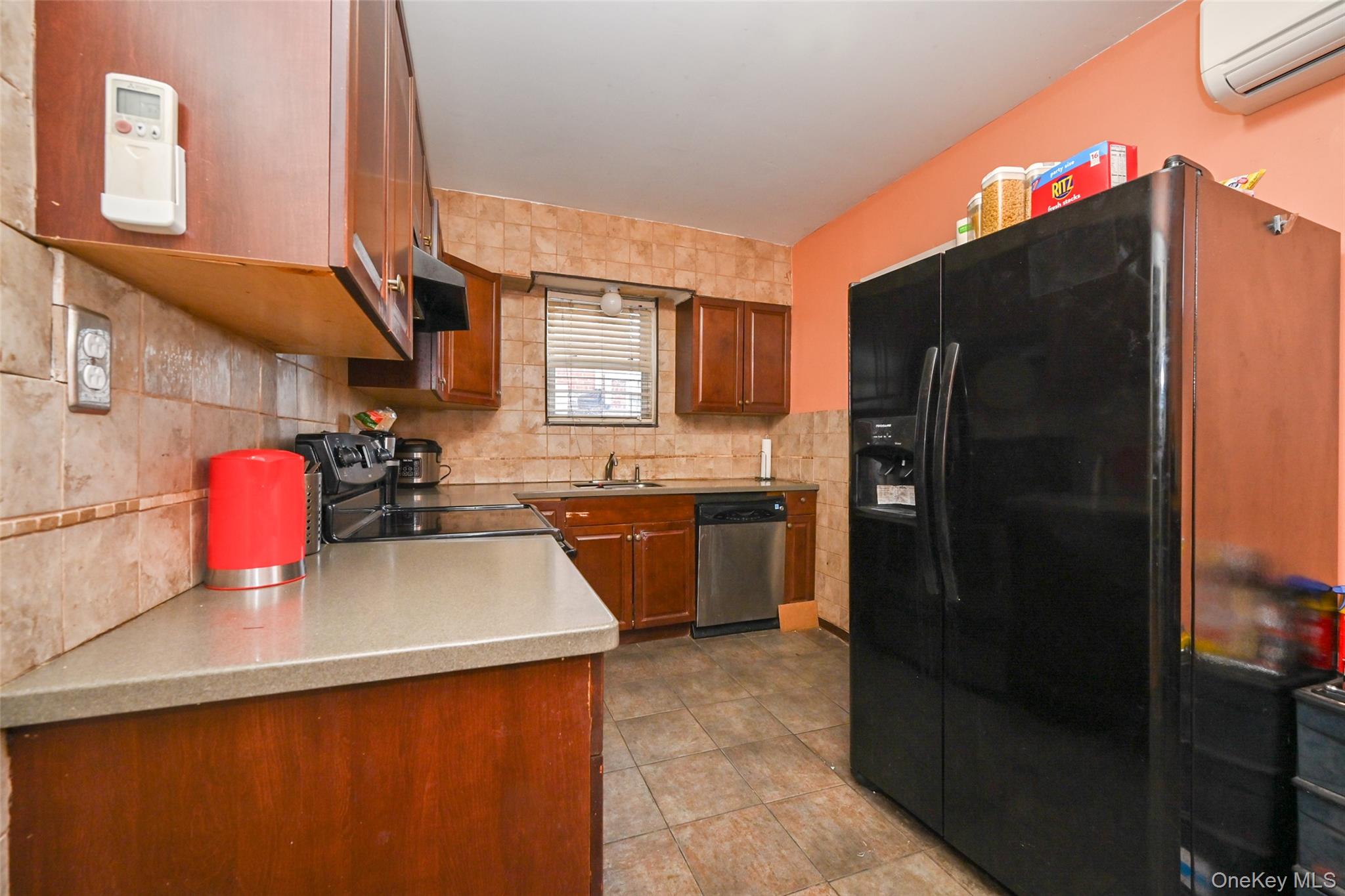 134-21 229th Street Queens, NY 11413 - Photo 7 of 25 a kitchen with a sink a refrigerator and a stove