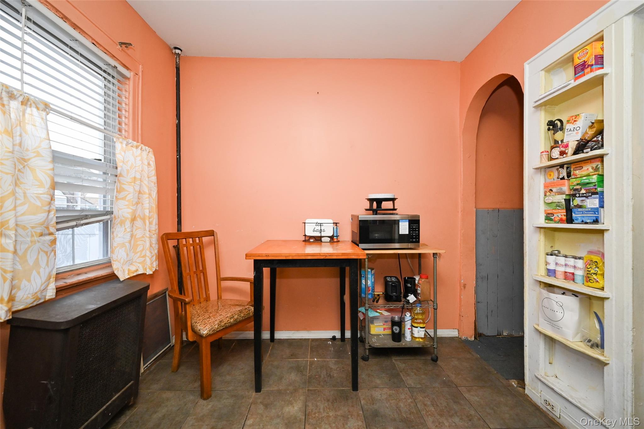 134-21 229th Street Queens, NY 11413 - Photo 8 of 25 a view of a workspace with furniture and a window