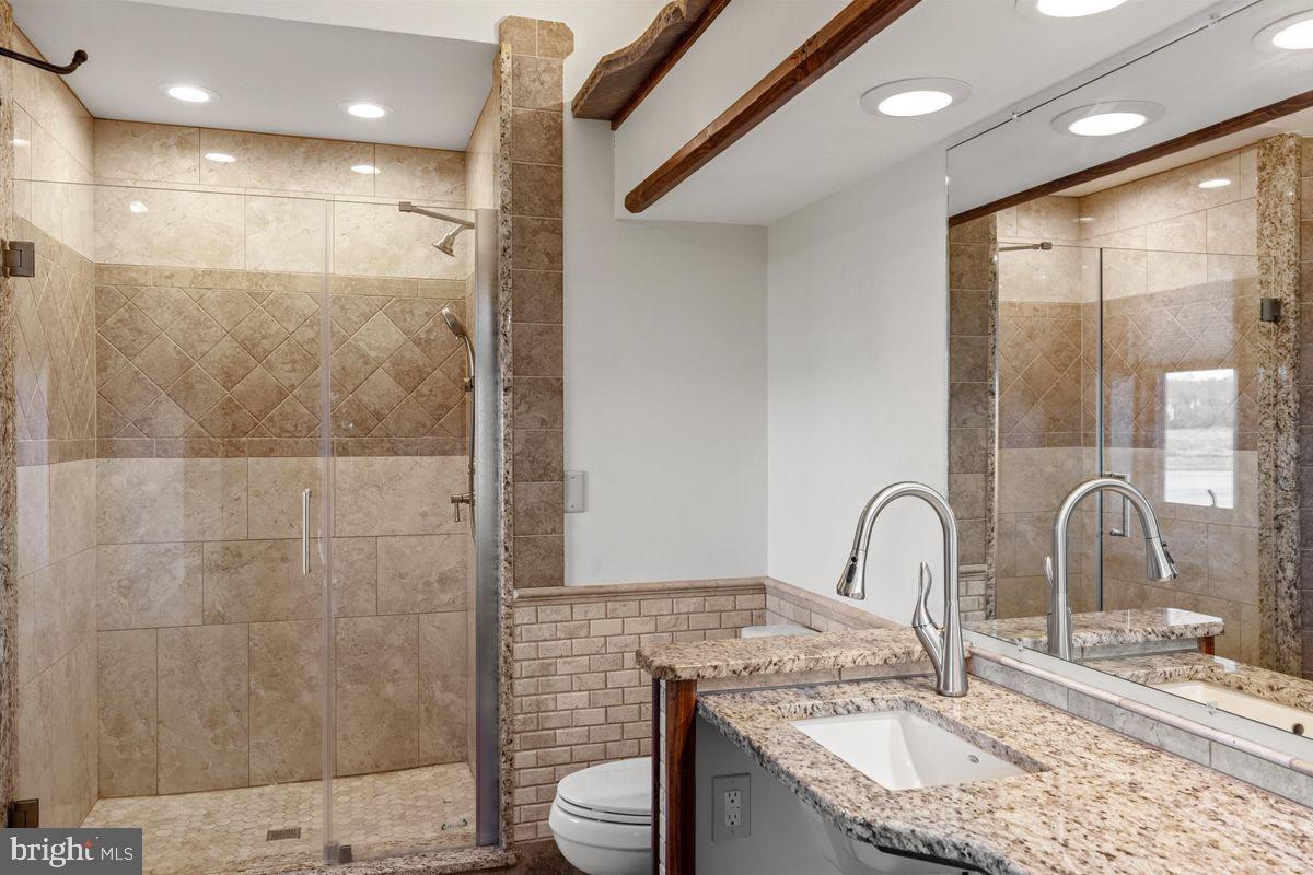 11 Beechnut Lane Willingboro, NJ 08046 - Photo 22 of 29 a bathroom with a granite countertop sink a toilet and shower