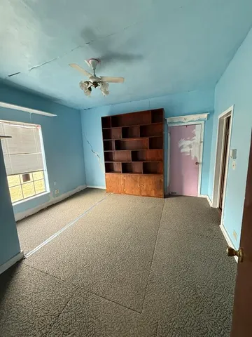 a large white kitchen with a large window