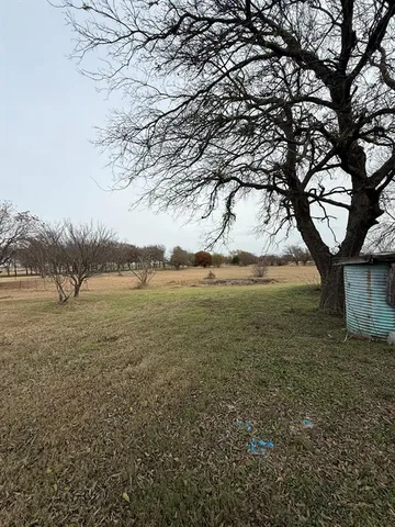 a front view of a house with yard and balcony