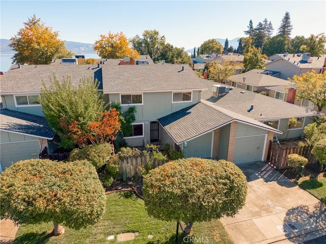 a bathroom with a granite countertop toilet sink and mirror