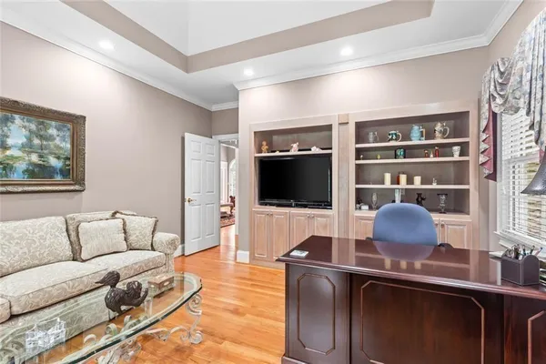 an empty room with a window and ceiling fan