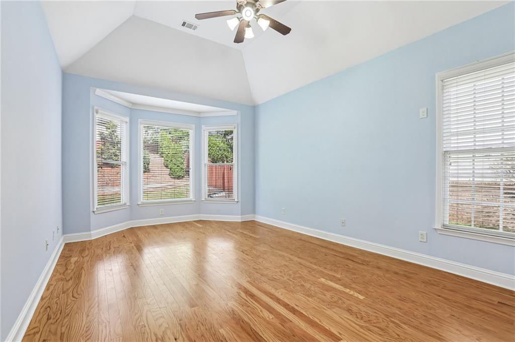 810 Freedom Way Cumming, GA 30040 - Photo 18 of 61 a view of an empty room with wooden floor and a window