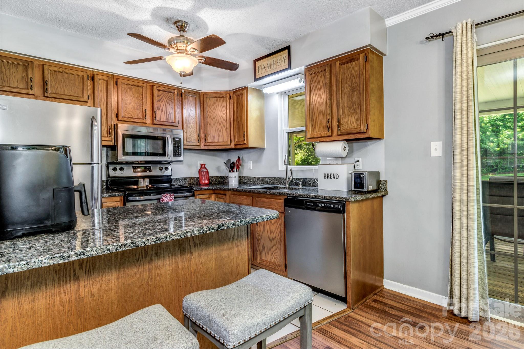 13 Spring Lake Drive Fletcher, NC 28732 - Photo 15 of 30 a kitchen with stainless steel appliances granite countertop a stove a sink dishwasher a refrigerator and a microwave