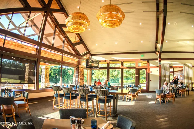 a living room with lots of furniture and large windows