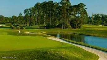 a view of a golf course with a lake