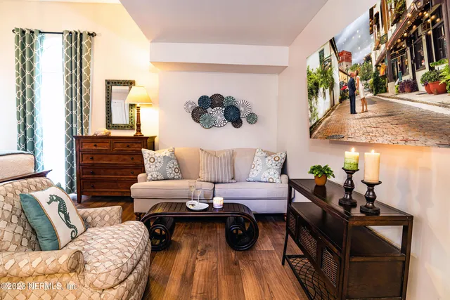 a living room with furniture and a floor to ceiling window
