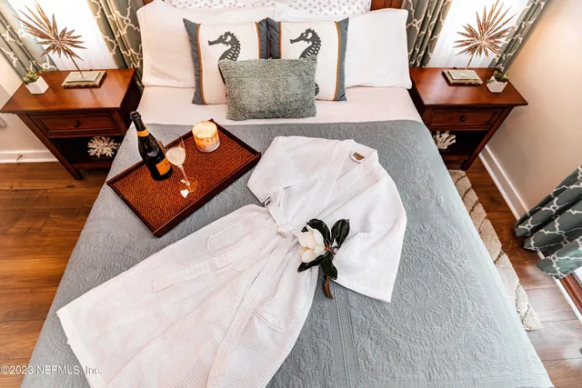 a living room with chairs and a wooden floor