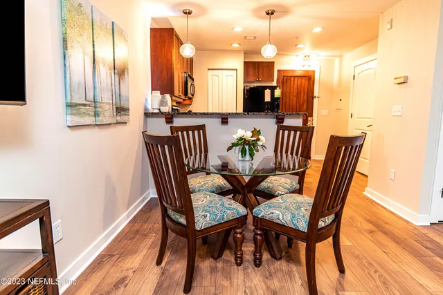 a dining room with furniture and wooden floor