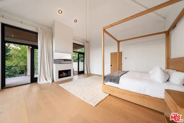 a spacious bedroom with a bed and a fireplace
