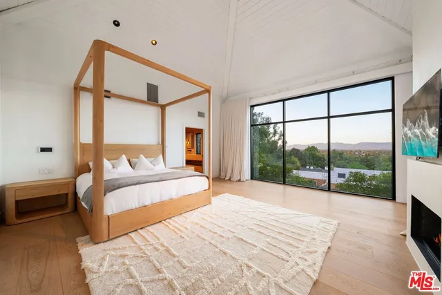 a bedroom with a large bed and a large window
