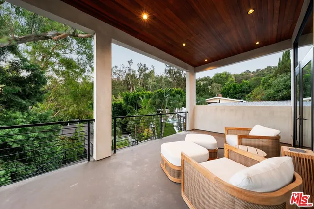 a balcony with furniture and a garden
