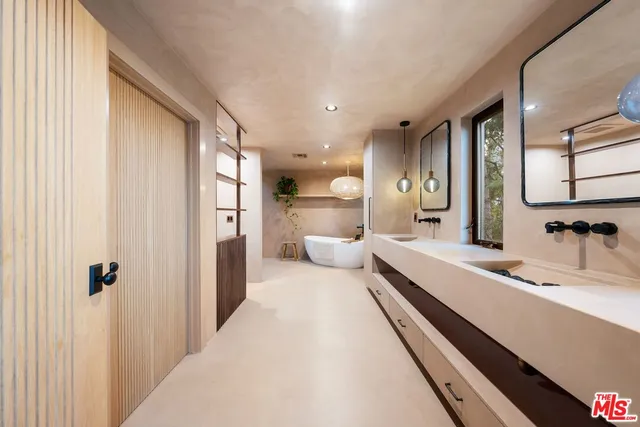 a bathroom with a double vanity sink mirror and shower