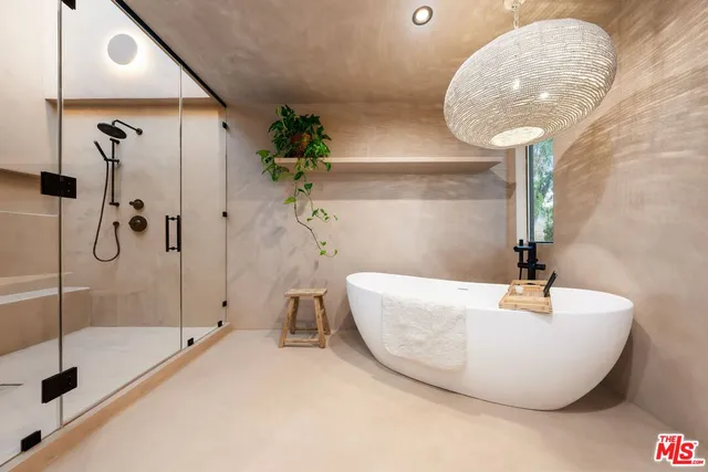 a bathroom with a bathtub and a shower
