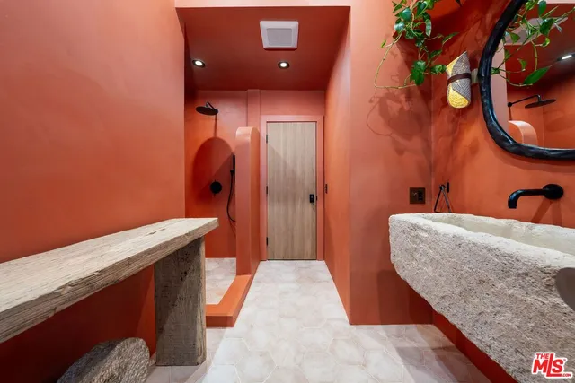 a bedroom with a bed and a mirror