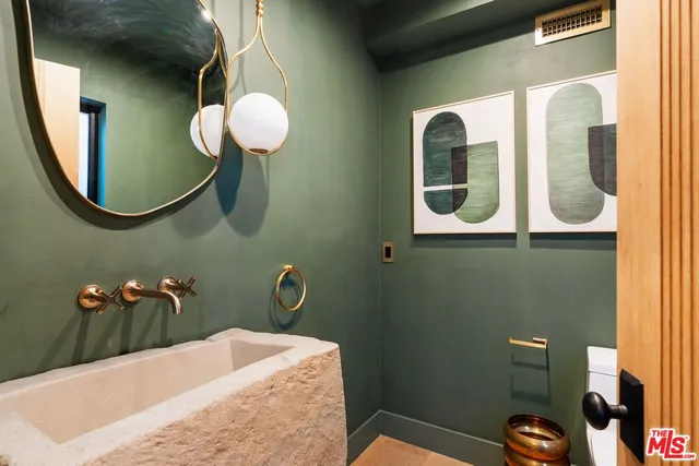 a bathroom with a sink mirror and vanity