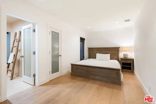 a bedroom with a bed and a walk in closet