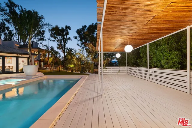 a swimming pool with outdoor seating and yard