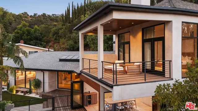 an aerial view of a house with a yard and potted plants