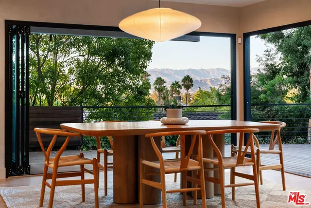a view of porch with a table chairs and a yard