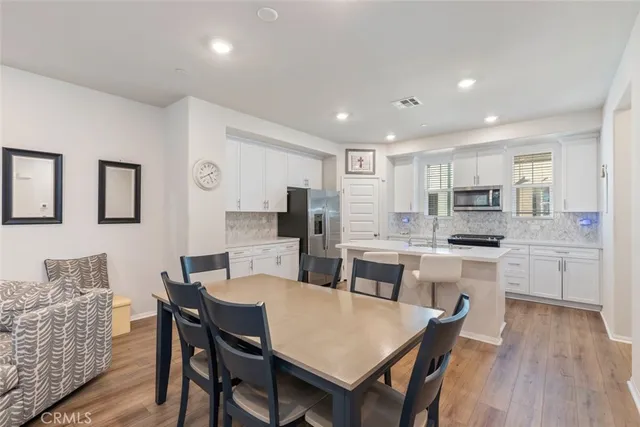 a large kitchen with a table and chairs