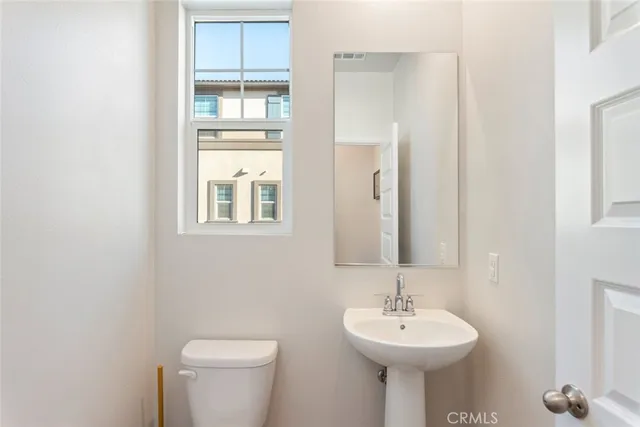 a bathroom with a sink a mirror and a toilet