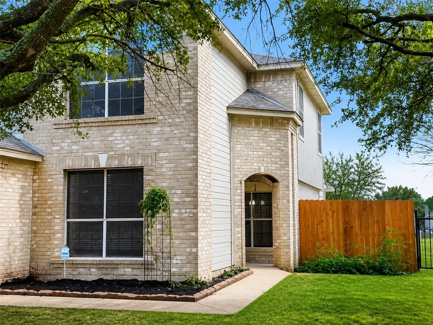 14828 Single Trace Austin, TX 78728 - Photo 2 of 30 Brick and siding exterior featuring an arched entryway