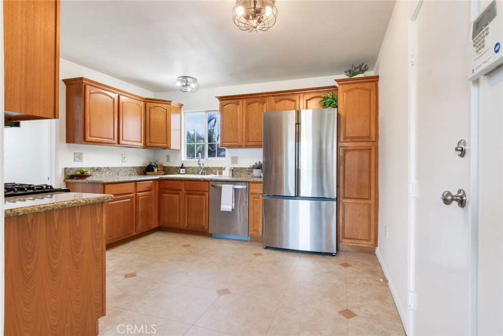 8955 Holly Lane Riverside, CA 92503 - Photo 4 of 32 a kitchen with stainless steel appliances granite countertop a refrigerator sink and cabinets
