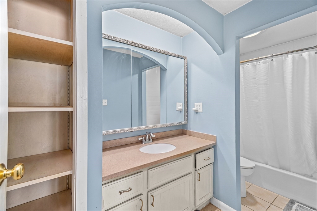 247 Washington, Unit 9 Winthrop, MA 02152 - Photo 11 of 18 a bathroom with a sink and a mirror