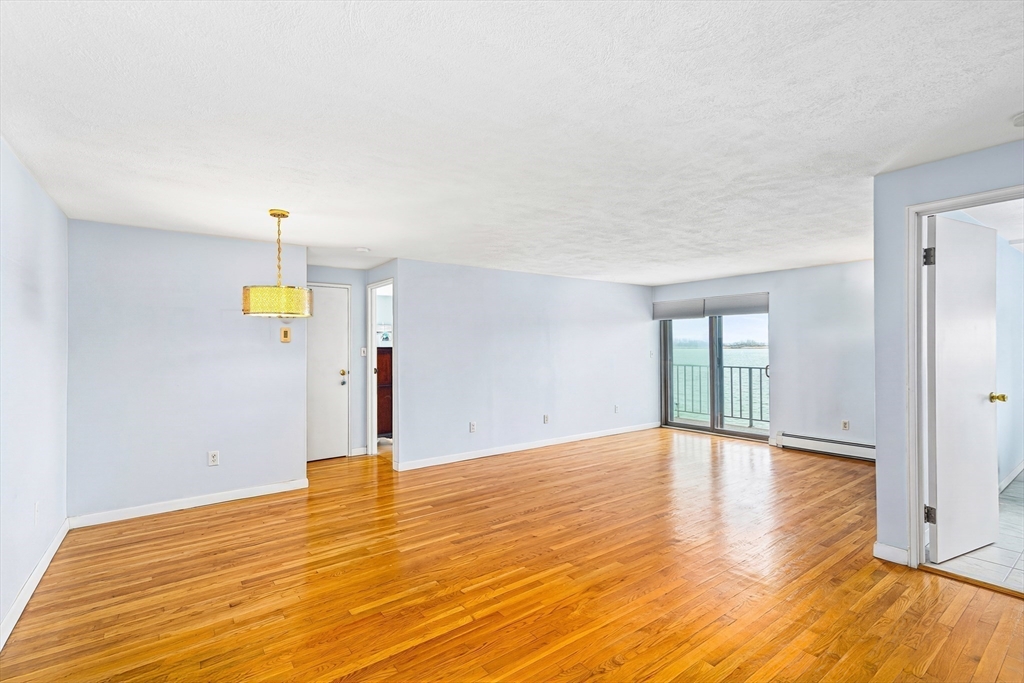 247 Washington, Unit 9 Winthrop, MA 02152 - Photo 5 of 18 a view of empty room with wooden floor