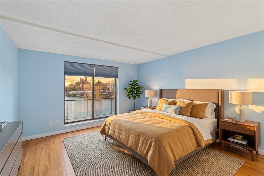 247 Washington, Unit 9 Winthrop, MA 02152 - Photo 6 of 18 a bed sitting in a bedroom next to a window