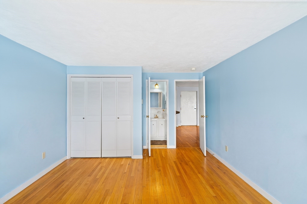 247 Washington, Unit 9 Winthrop, MA 02152 - Photo 7 of 18 a big room with wooden floor and closet