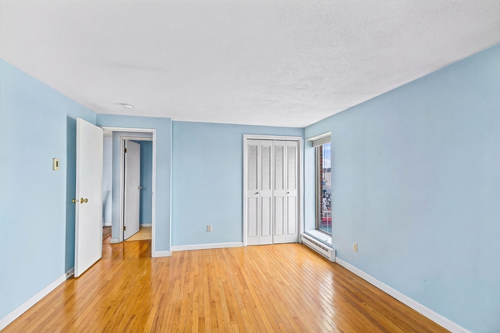 247 Washington, Unit 9 Winthrop, MA 02152 - Photo 9 of 18 a view of empty room with wooden floor
