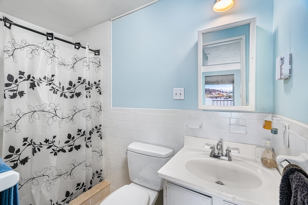 247 Washington, Unit 9 Winthrop, MA 02152 - Photo 10 of 18 a bathroom with a sink and a mirror