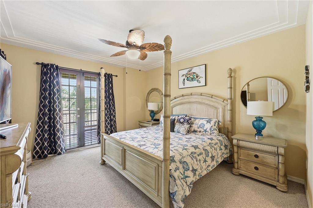 8986 Cambria Circle, Unit 2204 Naples, FL 34113 - Photo 12 of 36 a bedroom with a bed and a dresser