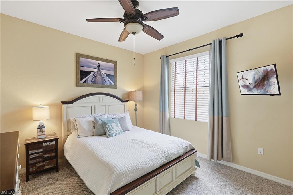 8986 Cambria Circle, Unit 2204 Naples, FL 34113 - Photo 17 of 36 a bedroom with a bed and a painting on the wall