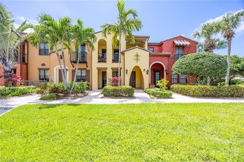 8986 Cambria Circle, Unit 2204 Naples, FL 34113 - Photo 2 of 36 a front view of multiple house with yard and green space