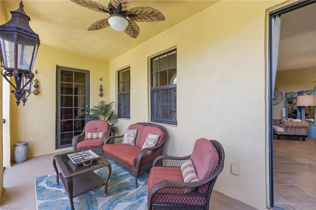 8986 Cambria Circle, Unit 2204 Naples, FL 34113 - Photo 22 of 36 a living room with furniture and wooden floor