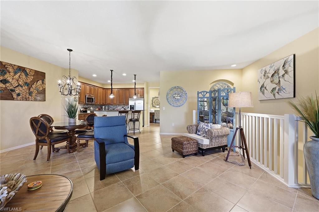 8986 Cambria Circle, Unit 2204 Naples, FL 34113 - Photo 6 of 36 a living room with furniture and a table