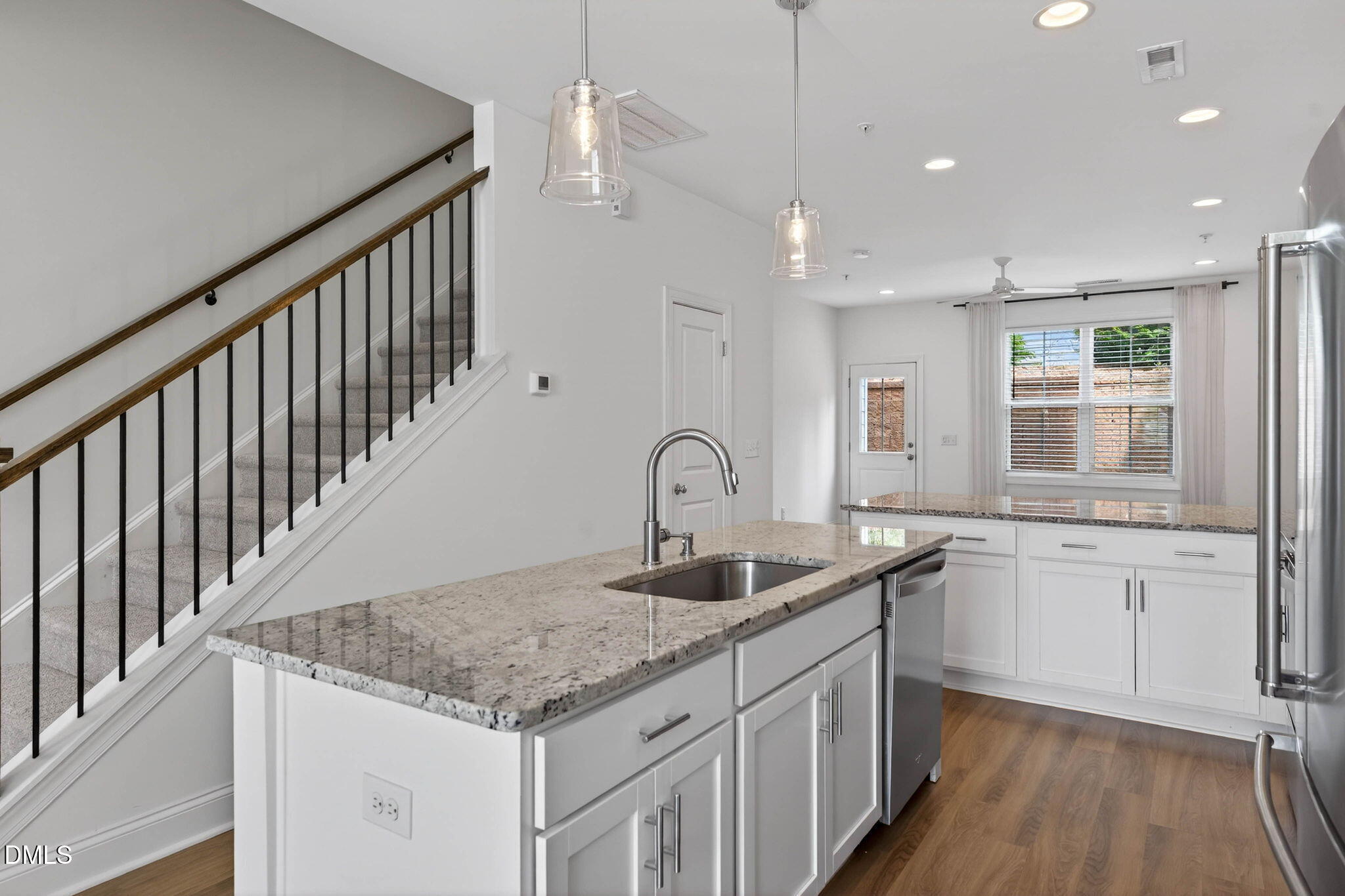 6820 Milligan Way, Unit 104 Raleigh, NC 27613 - Photo 11 of 39 a kitchen with granite countertop a sink and dishwasher with wooden floor