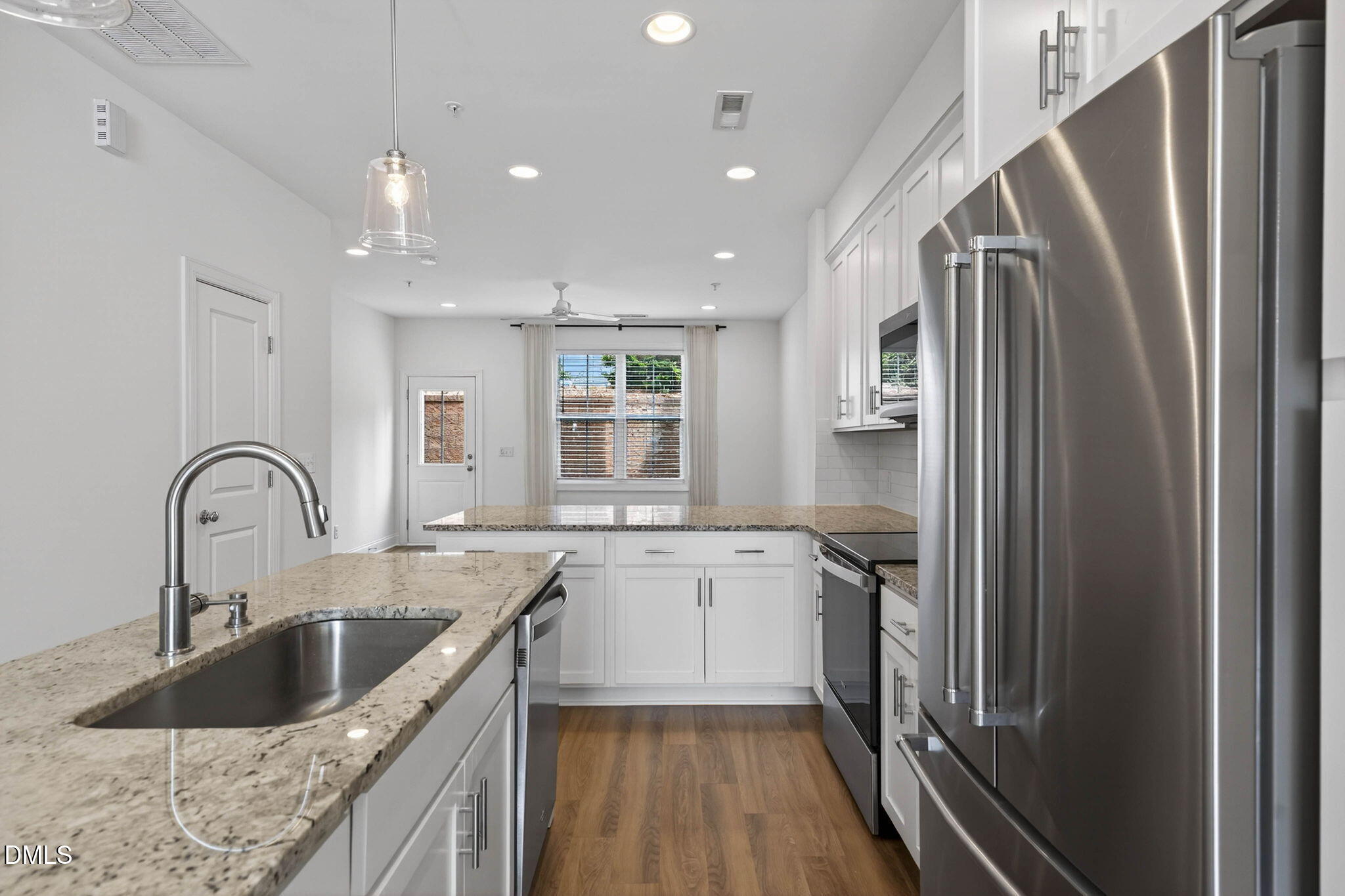 6820 Milligan Way, Unit 104 Raleigh, NC 27613 - Photo 12 of 39 a kitchen with stainless steel appliances granite countertop a sink stove and refrigerator