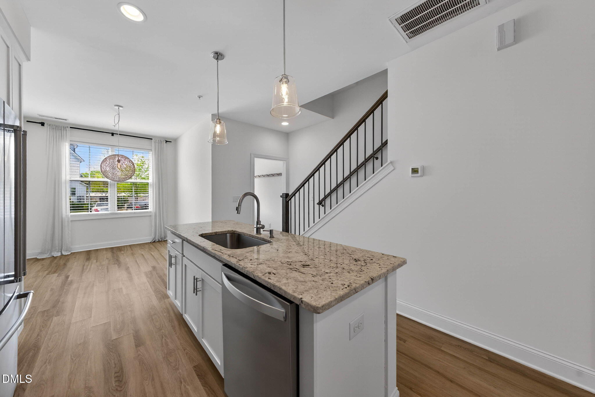 6820 Milligan Way, Unit 104 Raleigh, NC 27613 - Photo 13 of 39 a kitchen with stainless steel appliances granite countertop a sink and a stove