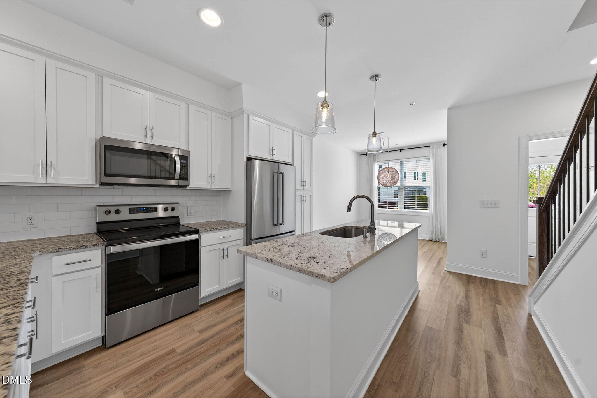 6820 Milligan Way, Unit 104 Raleigh, NC 27613 - Photo 14 of 39 a kitchen with stainless steel appliances granite countertop a kitchen island hardwood floor sink and stove