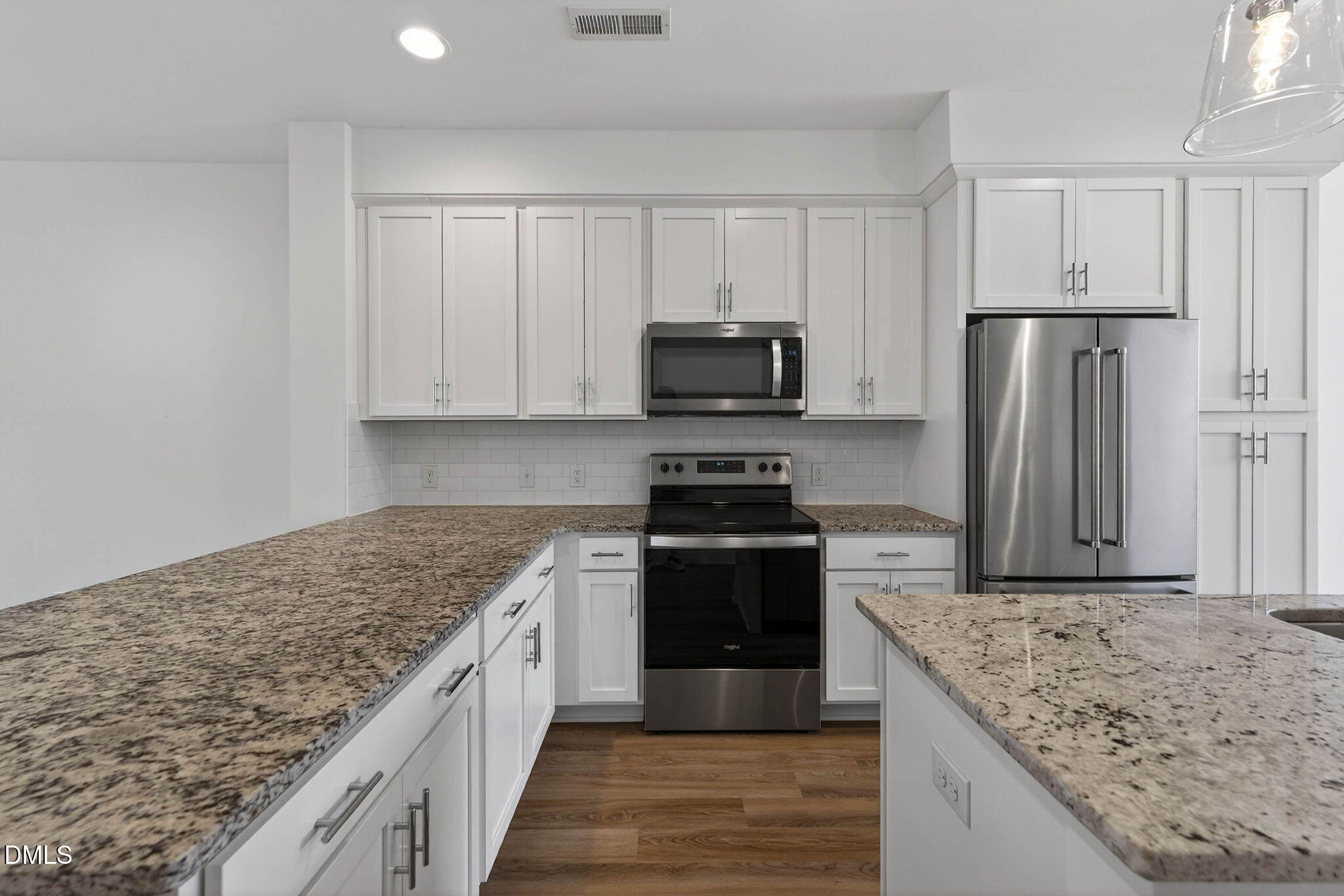 6820 Milligan Way, Unit 104 Raleigh, NC 27613 - Photo 15 of 39 a kitchen with stainless steel appliances granite countertop a stove a sink and a refrigerator
