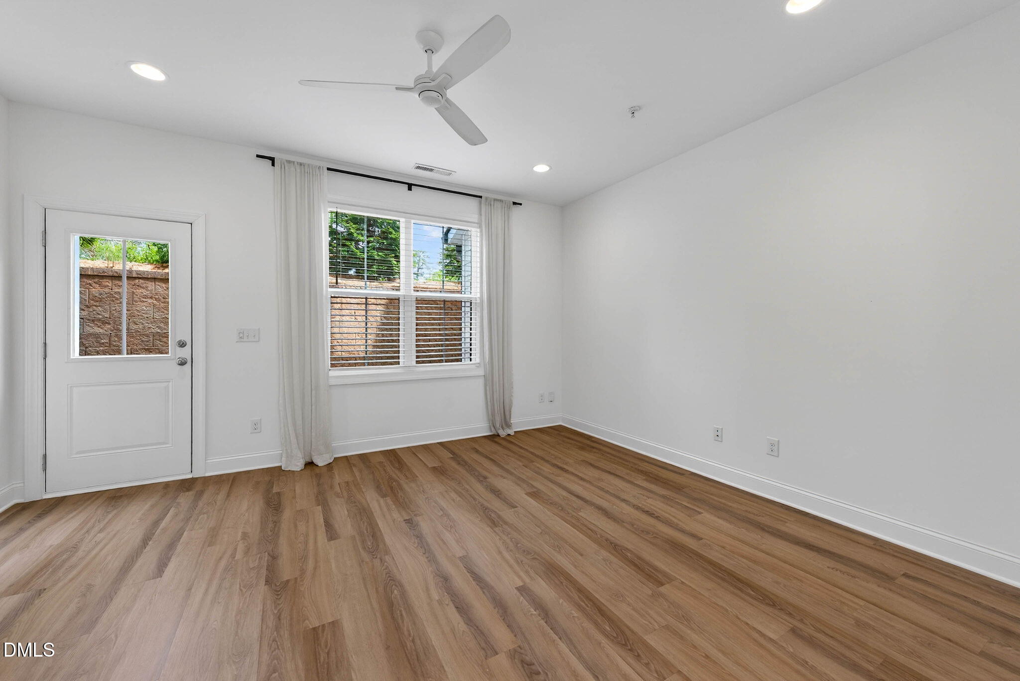 6820 Milligan Way, Unit 104 Raleigh, NC 27613 - Photo 16 of 39 a view of empty room with wooden floor and fan