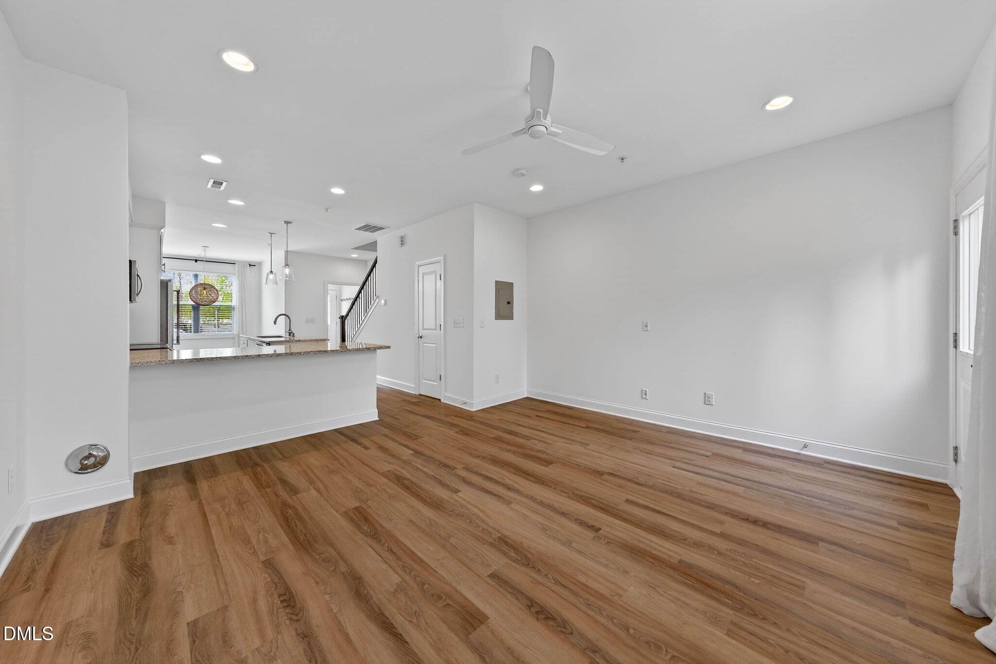 6820 Milligan Way, Unit 104 Raleigh, NC 27613 - Photo 18 of 39 a view of empty room with wooden floor and kitchen